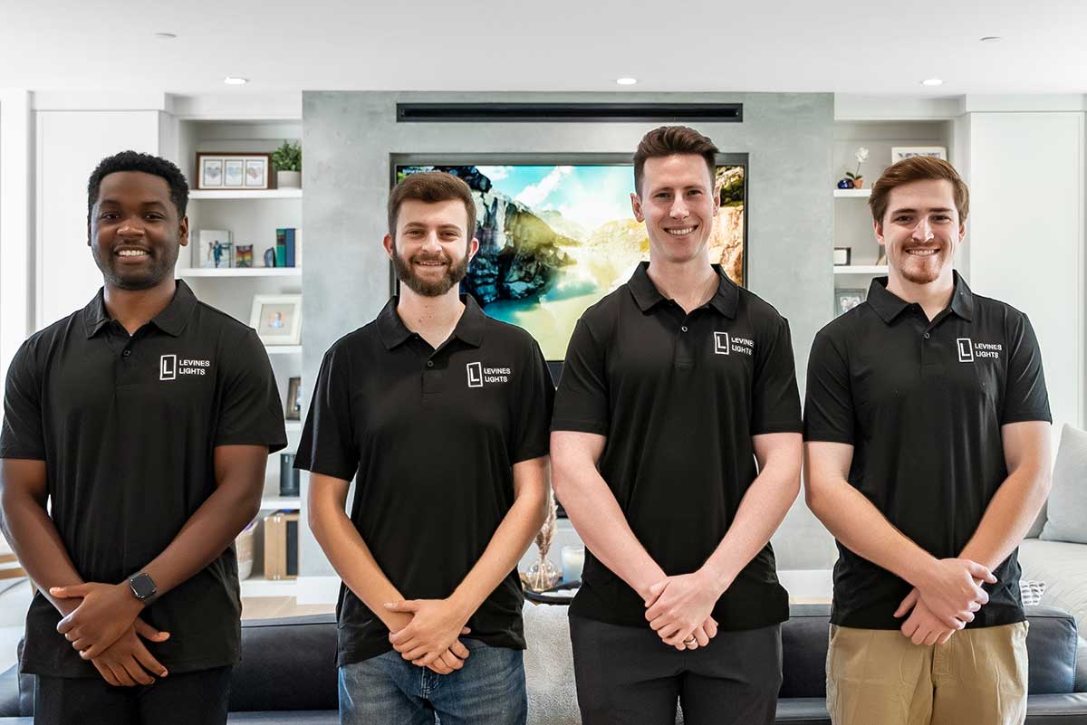 The Levines Lights team stands in front of a recent installation.