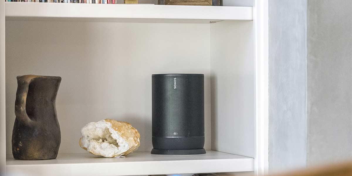 Black Sonos speaker on white shelf