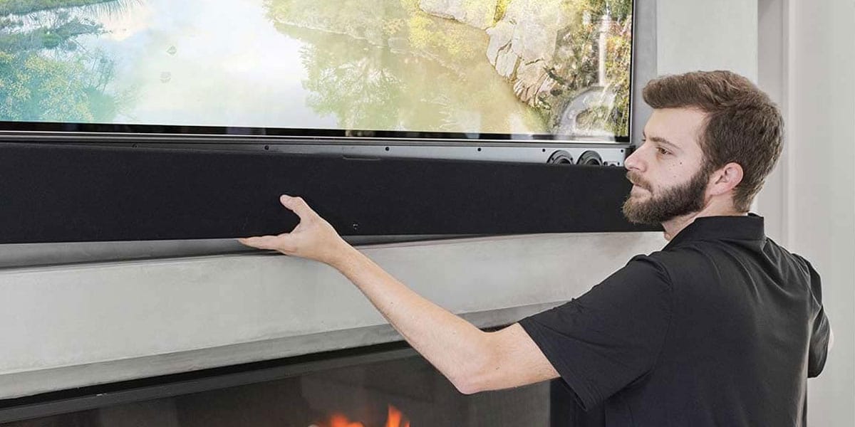 Justin installing a soundbar under TV.