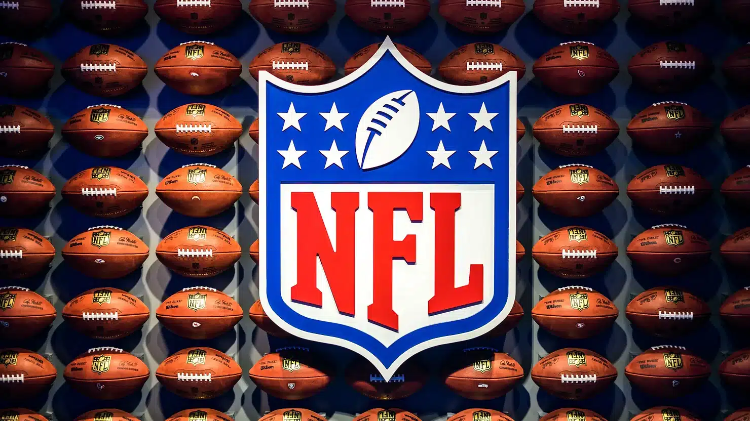 NFL logo with background of footballs
