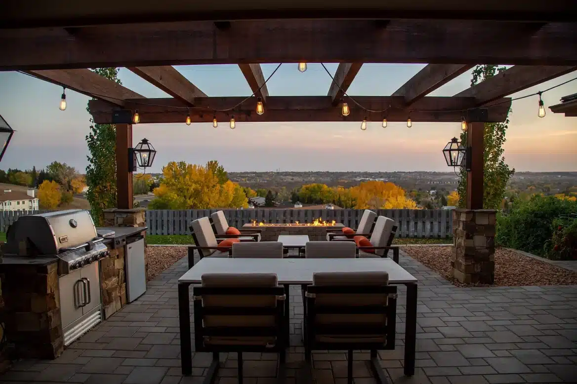 Patio with dining area and grill overlooking trees